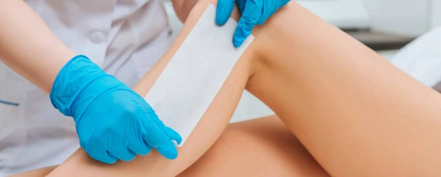 Expert applies wax strip to help reduce hair growth naturally