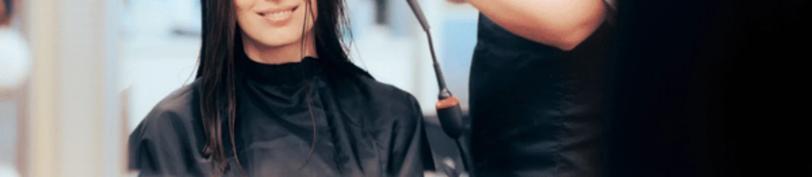 Stylist begins blow-drying client