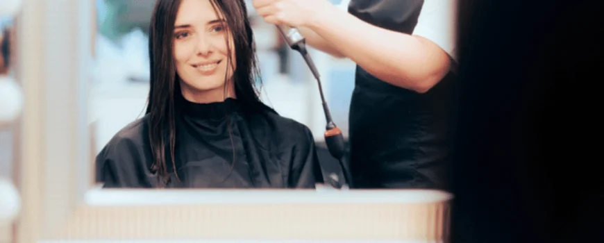 Stylist begins blow-drying client