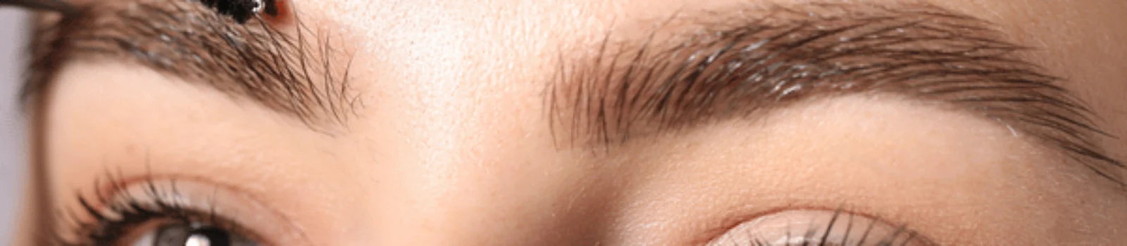 Close-up of brow brushing during appointment, showcasing lash and brow services for polished look today