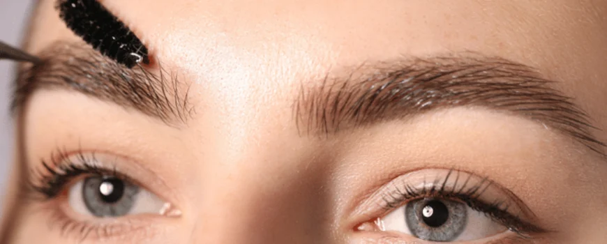 Close-up of brow brushing during appointment, showcasing lash and brow services for polished look today